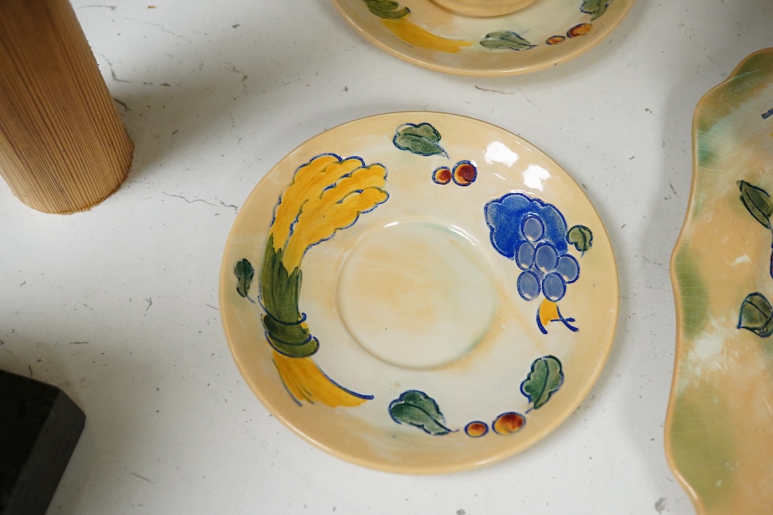 A collection of Doulton Brangwynware to include an oval dish, wall plate and two coffee cans and saucers, largest 32cm in diameter